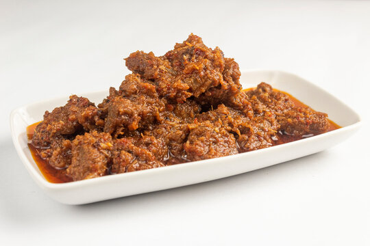 Rendang Daging or Beef stew traditional food from Padang, Indonesia. Made from Beef Stew and Coconut Milk with Various Herbs and spices. isolated on white background