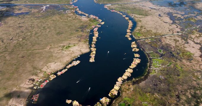 Uros floating islands on Lake Titicaca in Puno, Peru. Unique indigenous settlement and South American landmark. Aerial drone high angle