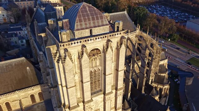 Aerial drone view of the apse and roof of the historic Saint Julien Cathedral in Le Mans, France, during a beautiful sunset
