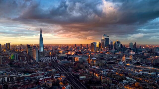 Panoramic aerial view of the London cityscape with Tower Bridge, River Thames and skyscrapers during a beautiful sunset