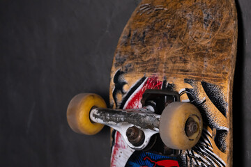 Close Up of Worn Skateboard Deck with Scratches and Wheels. © DenS