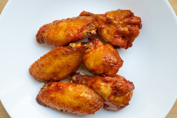 Spicy Roasted Chicken Wings and Drumettes Served on White Plate