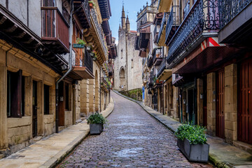 Obraz premium Historic Cobbled Street with Traditional Basque Houses, Old Town Architecture, Hondarribia