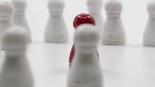 Red Pawn Stands Out Among White Pawns on White Surface, Close-Up Focus, Stock Media