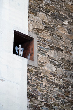 D&eacute;tail d&rsquo;un mur en pierre typique des maisons bretonnes, avec une petite ouverture abritant une statue d&eacute;corative. M&eacute;lange d&rsquo;architecture traditionnelle en pierre et d&rsquo;&eacute;l&eacute;ments modernes enduits.