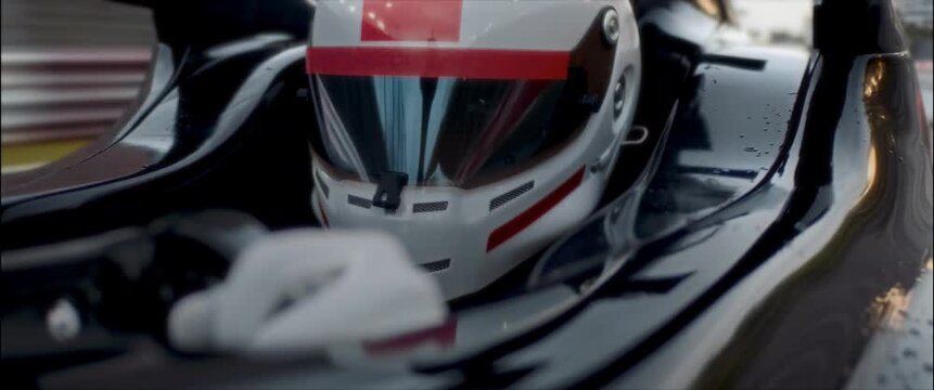 Close-up of a race car driver in a driving fast on a racing track