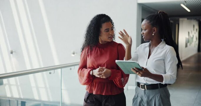 Business people, walk and talk in lobby with tablet for marketing internship, planning or research. Team, interns and discussion in office with tech for advertising campaign idea, review or feedback.