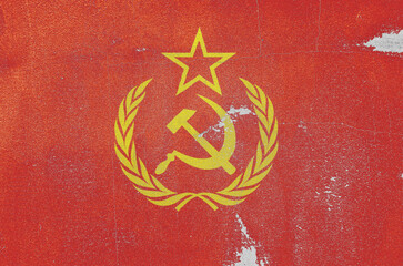 flag of the Soviet Union are painted on an old stone wall © Sofiia