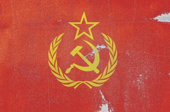 flag of the Soviet Union are painted on an old stone wall