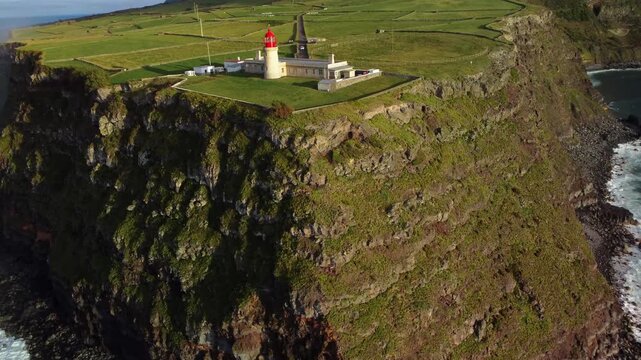 Aerial view af rock, lighthouse near ocean