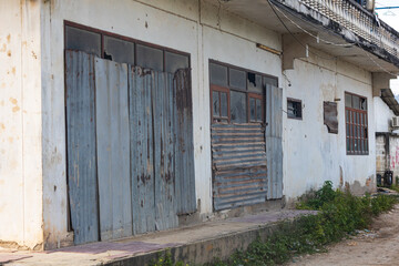 A building with a lot of broken windows and a lot of rust