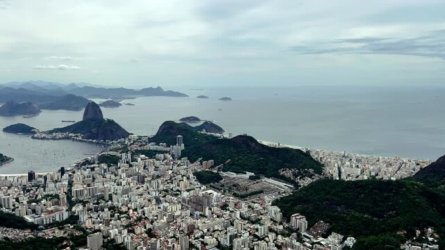 Sweeping high-angle panorama capturing the world-famous crescent of Copacabana and Leme beaches. P&atilde;o de A&ccedil;&uacute;car showcases the vibrant Atlantic coastline, iconic beachfront architecture.
