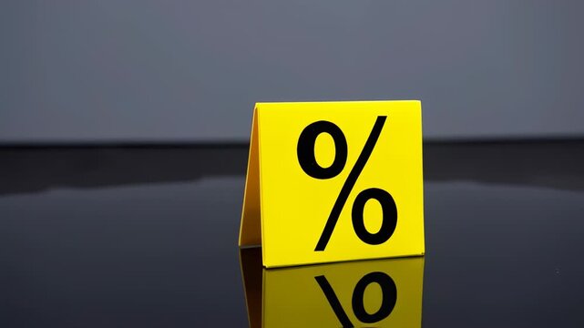 A bright yellow cube, displaying a black percentage sign, sits on a reflective surface