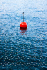 Plastic red bouy on a calm lake - concept image in jigsaw puzzle shape
