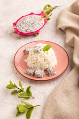 White Сottage cheese, Curd, with Pithaya on gray concrete and linen textile, side view, close up