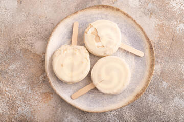 Сhocolate Ice cream in white glaze, on brown concrete, top view, flat lay, close up