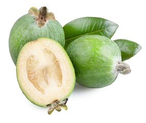 Fresh feijoa fruits, both whole and halved, are presented with green leaves against a clean white background. This tropical produce is ready for healthy consumption.