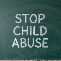 Stop child abuse message handwritten with white chalk on a green chalkboard background promoting awareness