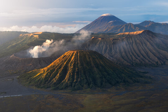 Aerial view of Mount Bromo's volcanic landscape, where earthy tones meet the sky, creating a dramatic contrast, Pasuruan Regency, Jawa Timur, Indonesia.