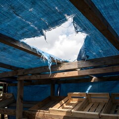 abandoned market stall with torn tarp roof