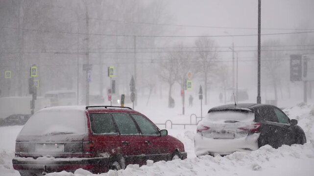 Snow-covered roadside, car stuck, frozen, deep snowdrifts covering bumpers, blurred traffic lights, passengers making their way through a storm in background, immediate help, tense cold atmosphere.
