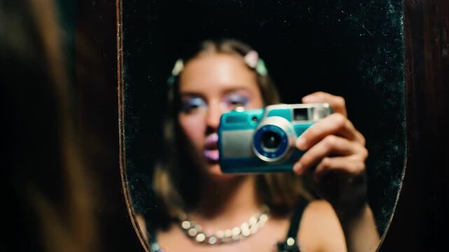 A person is taking a picture of themselves in a mirror, with a camera reflection