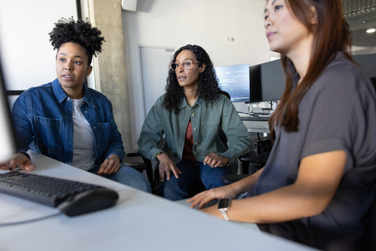 Women collaborating on tech solutions in an office
