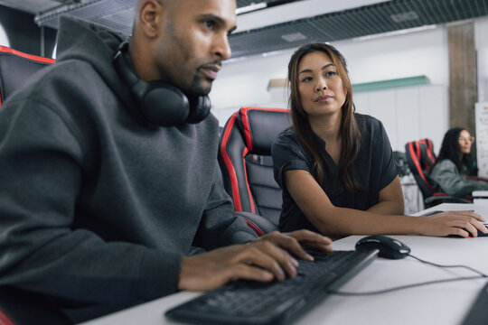 Game developers Collaborating and Sharing Ideas at Work