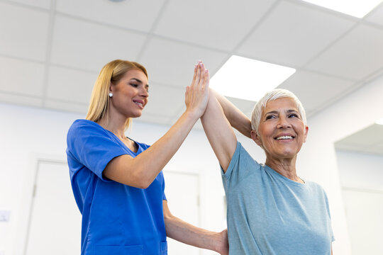 Shoulder mobility exercise. Senior woman lifting arm with help of female therapist in clinic. Healthcare and medicine concept, elderly patient during rehabilitation for joint and muscle problems.