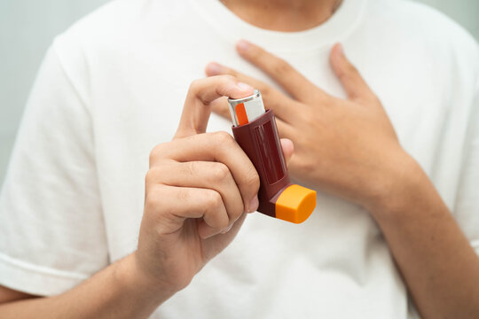 Asthma and chronic obstructive pulmonary disease COPD, Asian teenage using metered dose inhaler MDI.