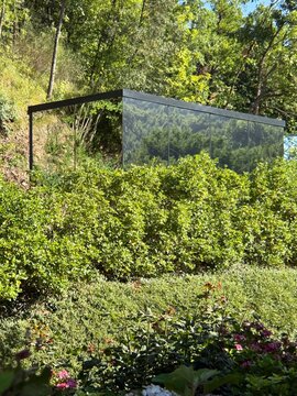 Glass-Walled Modern Structure Hidden Among Tuscan Greenery