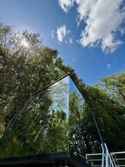 Mirrored Glass Cabin Reflecting Forest in Tuscany