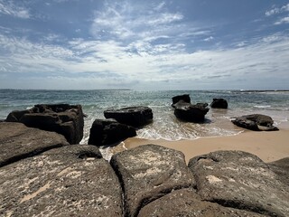 Rocky Beach with Waves and Blue Sky
