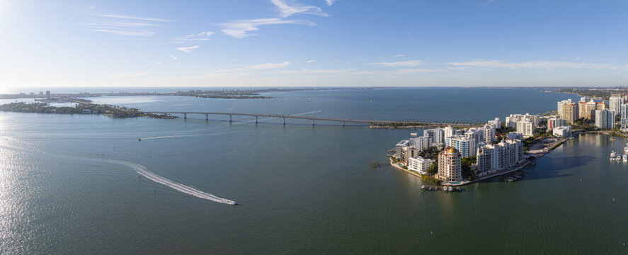 Aerial view of Ringling Bridge stretching across the water connecting islands with a city skyline in the distance, Sarasota, Florida, United States.