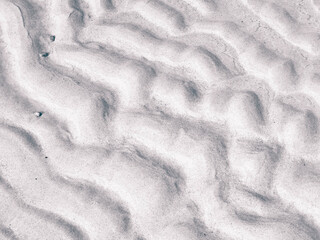 Traces of waves on sand as a natural background.