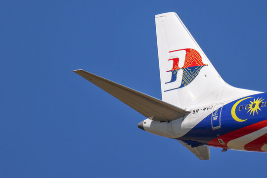 Perth, Western Australia, Australia - November 29 2025: Malaysia Airlines airplane tail fin, or empennage, with logo. Clear blue sky, copy space. Rear assembly providing stability and control