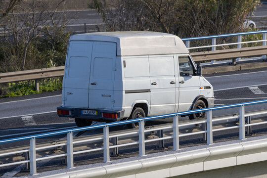 White iveco daily van driving on highway