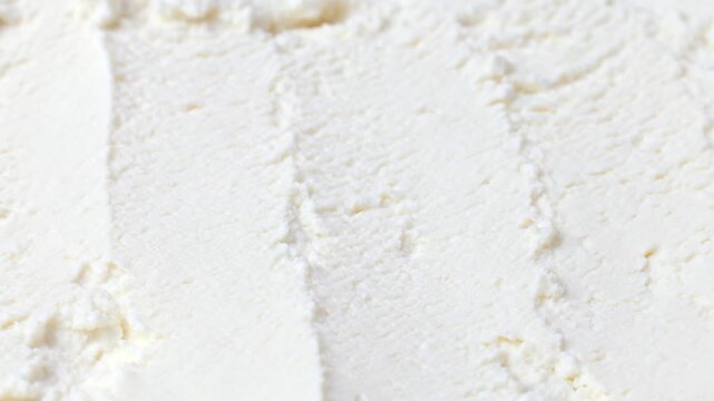 Fresh white ricotta cheese texture circle rotation close up