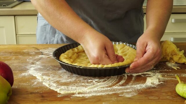 Woman makes an apple pie

