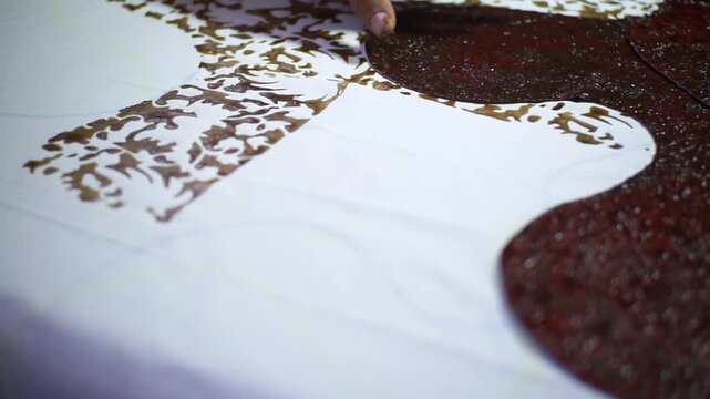 Traditional Batik Stamping Process on Fabric by Artisan