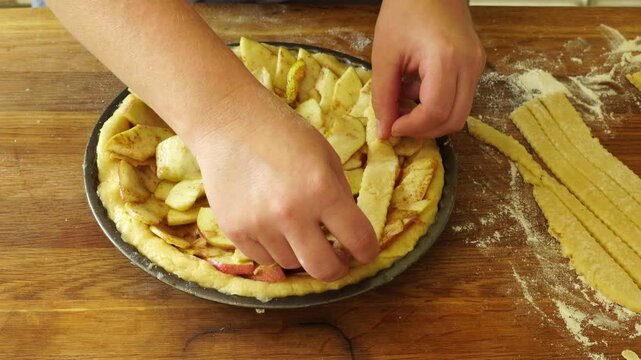Woman makes an apple pie
