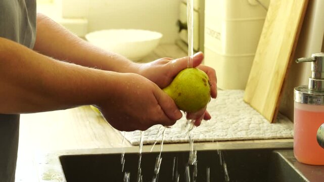 Woman cuts apples and pears for pie
