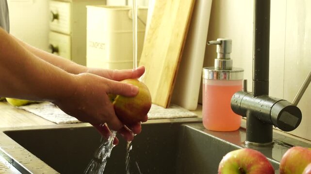 Woman cuts apples and pears for pie
