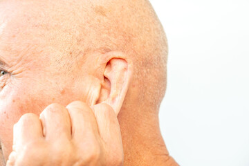 Fototapeta premium man touches ear canal, suggesting discomfort from earwax buildup or hearing issues, Signs of blocked ears, ossibly experiencing hearing loss or pressure, health concern, self-care procedure