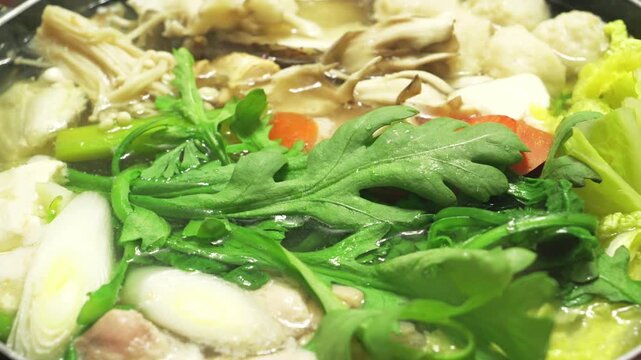 Japanese Hot Pot Cooking in Winter &ndash; Steaming Nabemono with Vegetables and Fish Close-Up