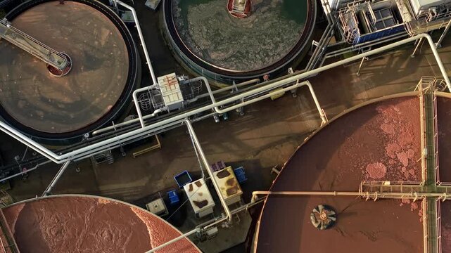 Close up aerial view of bubbling brown liquid in industrial oxidation ditches at a UK waste plant illustrating the biological treatment of effluent.