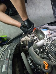 Oil and filter change on an old Skoda car. Close-up shots of motor oil pouring, filter replacement, and engine bay during routine garage maintenance Focus on precision.
