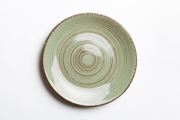 Top view of isolated of colored background empty round green plate for food. Empty dish with space for your design