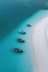 Naklejka premium Aerial view of boats on turquoise waters near white sandy beach