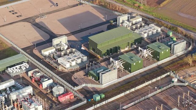 Aerial footage of massive synchronous condenser units at Walpole substation supporting the National Grid Pathfinder project and green energy transition.
